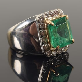 18K gold 6.0ct natural emerald and diamond mounted ring. Emerald cut stone measures 10.91 x 10.65 x