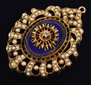 14K gold openwork pendant with blue enamel decoration. Set with a central raised diamond and