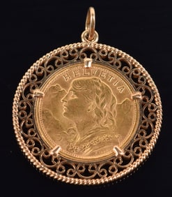 1935 Swiss 20 Franc gold coin mounted in gold openwork filigree frame. 30.6mm diameter. 10.7 grams.