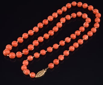 14K gold coral beaded necklace. Beads approx. 8.3mm diameter. Clasp marked 14K. 24in length. 53.9