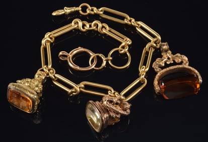 Antique heavy 14K gold watch chain with 3 fobs. Chain length: 14in. Marked on clasp. Approximate