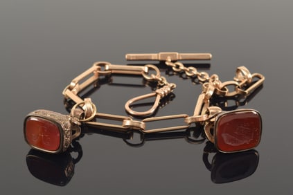 Antique heavy 14K gold watch chain together with 2 signet fobs. Chain with alternating long and shor