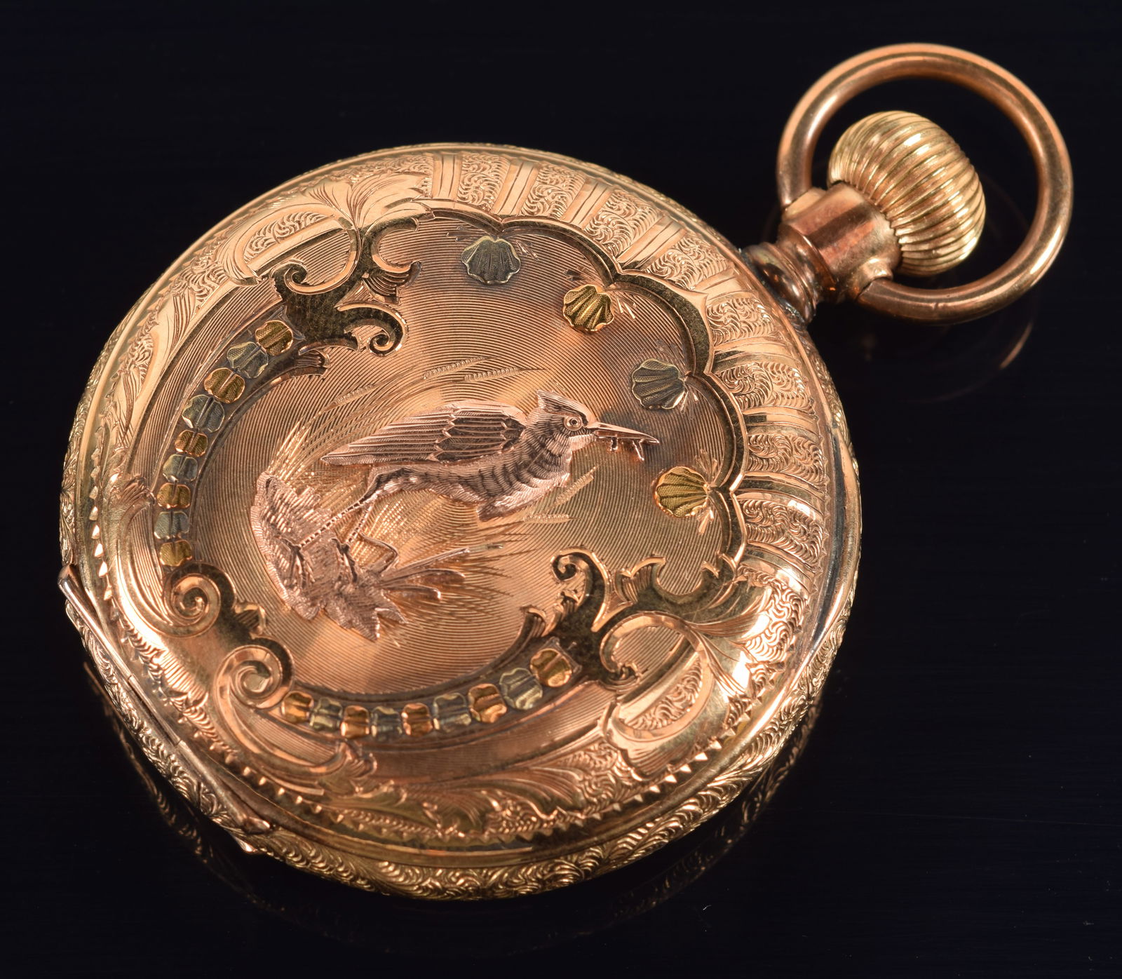 14K tri color gold American Waltham Watch Co. pocket watch. Case with raised and engraved decoration: 14K tri color gold American Waltham Watch Co. pocket watch. Case with raised and engraved decoration in white, yellow and rose gold. One side with crane and shell decoration, the other with flowers an
