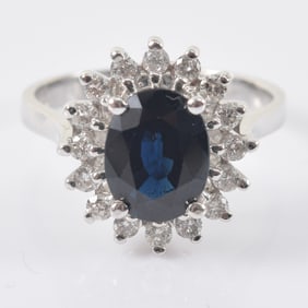 14K white gold natural Australian sapphire and diamond mounted ring. Oval cut sapphire measures 9.11
