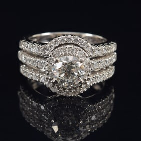 14K white gold 1.03ct diamond solitaire ring. 3 channel halo setting with round cut diamonds. Center