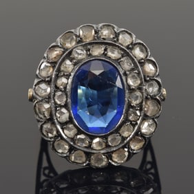 Antique silvered gold ring with diamonds and synthetic sapphire. Oval cut sapphire measures 9 x