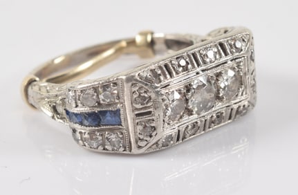 Edwardian platinum diamond and sapphire ring. Scrolled and pierced setting. 3 central diamonds,