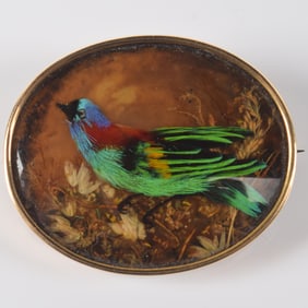 Antique 14K gold framed bird diorama pin. Bird made of various feathers, background of various plant