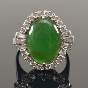 Retro jade and diamond platinum ring. Central jade stone of a deep green color. Measures approx.