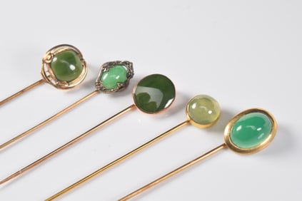 [5] 14K gold jade stick pins. 1) 14K marked oval jade cabochon. Stone measures 13.5 x 9.5mm. Highly