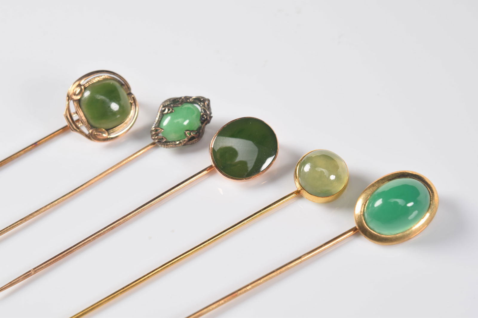 [5] 14K gold jade stick pins. 1) 14K marked oval jade cabochon. Stone measures 13.5 x 9.5mm. Highly (1 of 9)