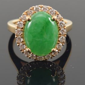 14K gold jade and diamond ring. Jade cabochon 12.9 x 9.6mm. Surrounded by halo of small round cut