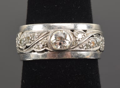 Vintage platinum and diamond eternity ring. Pierced scrollwork design. Largest diamond measures 4.8