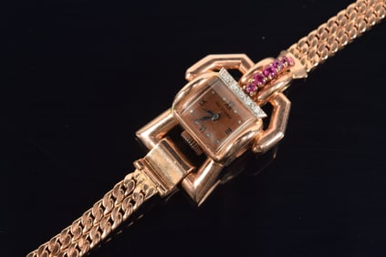 Paul Ditisheim 14K rose gold retro ladies wristwatch. Buckle form set with diamonds and rubies.