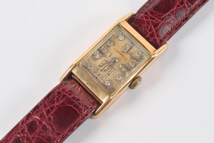Longines vintage 14K gold and diamond wristwatch. Dial set with round cut diamonds at the numerals.
