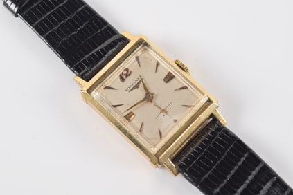 Longines 14K gold wristwatch. Leather band. Case marked 14K and maker's mark. Band length 8.25in.