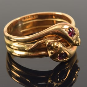18K gold English snake's head ring set with rubies. English hallmarks and maker's mark of "NJ" or