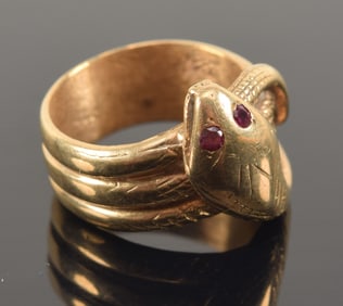 14K gold coiled snake form ring. Ruby eyes. Unmarked, tests as 14K. Ring size 6.25. 10.4 grams.