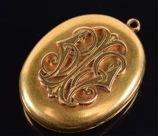 Victorian 14K gold pendant locket. Raised monogram. Hair keepsake on interior. 1.5in length. 17.4