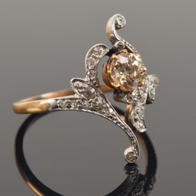 Antique 14K gold diamond ring. Fancy bypass style setting in white gold with diamonds surrounding a