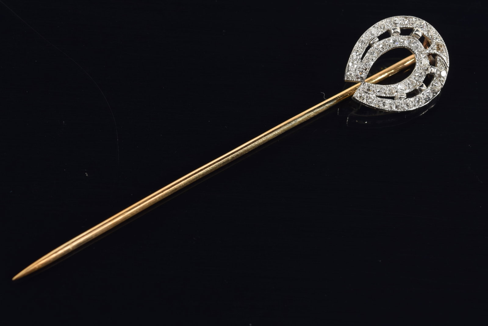 14K white and yellow gold diamond mounted horseshoe stick pin. 2.75in length. Unmarked, tests as: 14K white and yellow gold diamond mounted horseshoe stick pin. 2.75in length. Unmarked, tests as 14K. 2.8 grams.