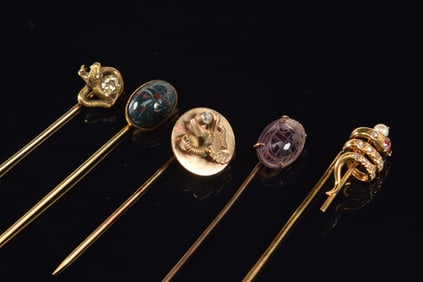 Lot of 5 gold stick pins. 1) 18K gold coiled snake set with diamonds, ruby, and pearl. Hallmarked.