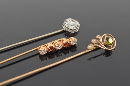 Lot of 3 vintage gold stick pins. 1) Peridot and seed pearl mounted pin. Tests 14K. 2) Art Deco