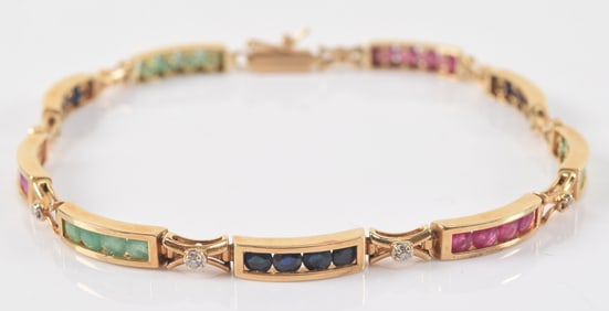 14K gold bracelet mounted with diamonds and panels of 4 cut stones including emerald, ruby, and