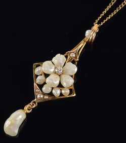 10K gold pearl and diamond pendant necklace. Flower form pearls with diamond center and drop pearl.