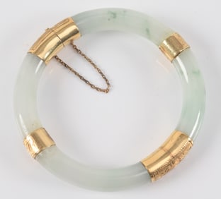 14K gold Chinese jade brangle bracelet. Stone of a white color with green markings. 14K gold mounts