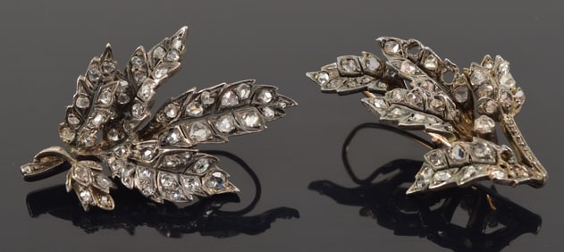 Antique silvered gold diamond mounted leaf form earrings. Near matching designs. Largest diamond