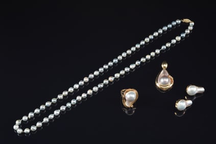 14K gold pearl jewelry suite. To include: 1) Long pearl necklace with gold pendant with pearl and