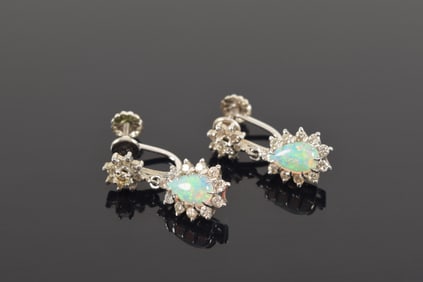 Pair of 14K white gold opal and diamond drop earrings. Unmarked but test as 14K. 0.9in length. 4.3