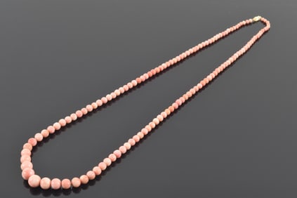 14K gold graduated coral bead necklace. Pale pink/angel skin color. 14K gold clasp. Largest coral