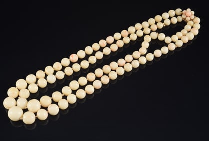 14K gold angel skin coral beaded dual strand necklace. Clasp set with additional coral beads and