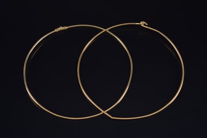 [2] 14K gold wire neck rings. Both marked 14K. 4.75 and 4.5in diameters. One with repair. 24.3 grams