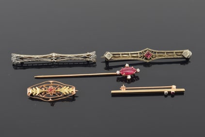 Lot of 5 vintage pins. 1) Ruby and diamond mounted stick pin. Ruby measures 10 x 5mm. Marked 14K. 2)