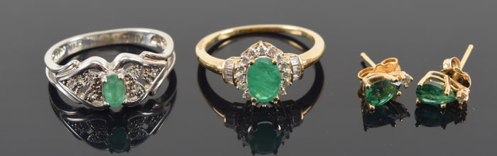 Lot of emerald jewelry. 1) 14K gold emerald with halo of tiny diamonds. Ring size 7. 2) Sterling