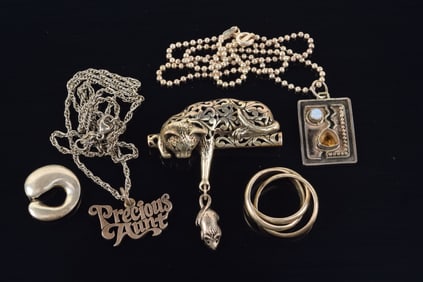 Lot of silver jewelry. To include: 1) Cat pin with "mouse" dangle. 1.75 x 2in. 2) Modern style gem
