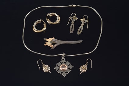Lot of sterling silver and gold jewelry. To include: 1) Demarcay 14K and silver floral sprig pin. 2)