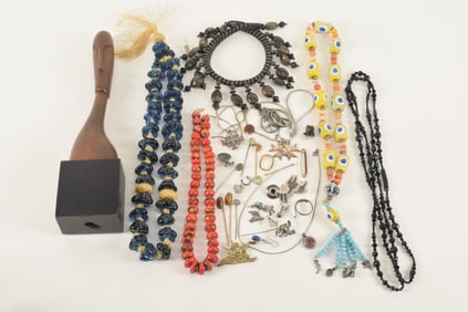 Grouping of costume jewelry necklaces and modern wood carving.