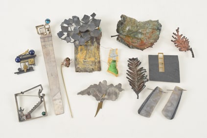 Selection of modern designer jewelry pins, bookmark, earrings, etc. Some silver with gold elements.