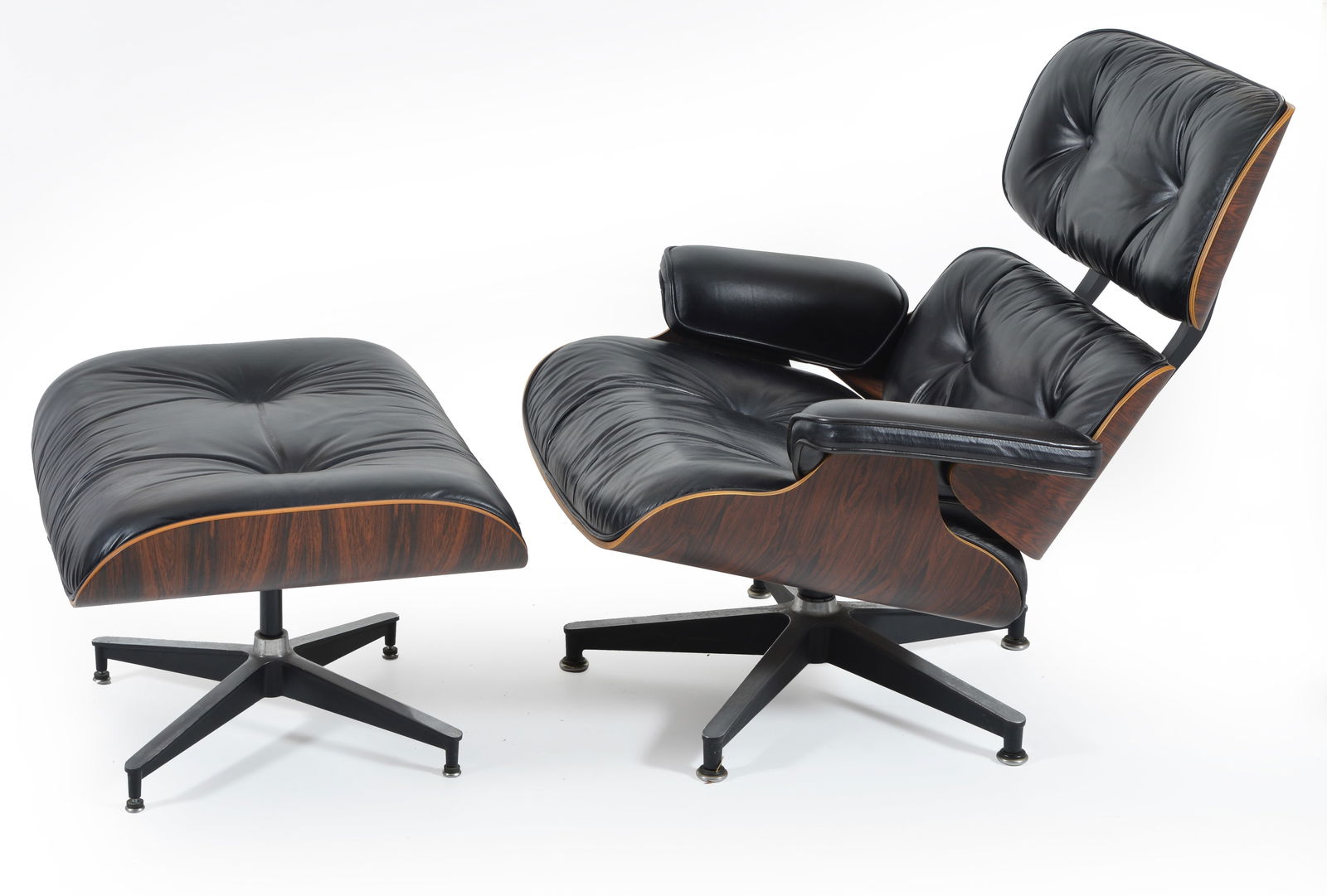 Charles and Ray Eames lounge chair and ottoman, late 20th Century. Rosewood laminate with black (1 of 5)