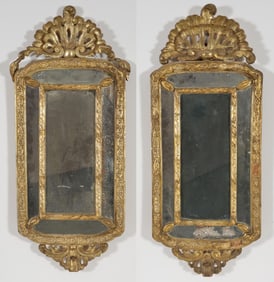A near pair of Continental looking glasses with gilt gesso frames and shell form crests, late 18th
