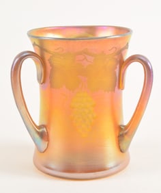 Tiffany Studios three handled favrile glass loving cup with intaglio grape and vine decoration,