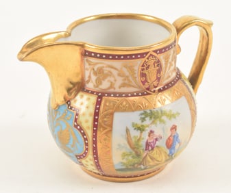 An Austrian Royal Vienna style small pitcher with decorative panels. Height 2.25 in.