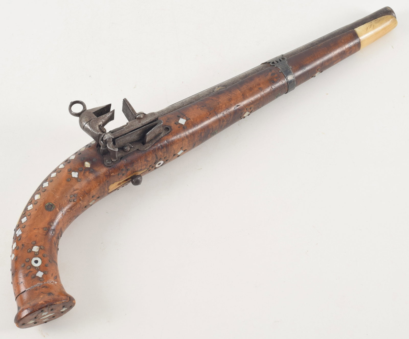 Finely decorated Caucasian miquelet lock pistol, late 18th/early 19th century. Lockplate and breech: Finely decorated Caucasian miquelet lock pistol, late 18th/early 19th century. Lockplate and breech elaborately decorated with engraving and traces of gilding. Stock inlaid with bone and mother of pea