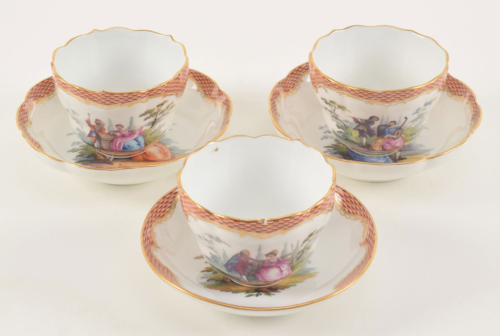 3 Meissen tea cups and saucers with various hand painted courting scenes. 2 saucers with scalloped: 3 Meissen tea cups and saucers with various hand painted courting scenes. 2 saucers with scalloped edge. Minor imperfections. Cup height 2.25, saucer diameter 5.25 in.