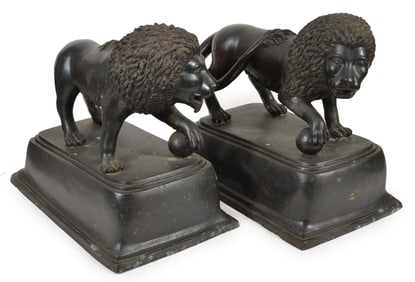 Pair of cast bronze and patinated standing lions with ball, 20th Century. Height 24 in, length 27