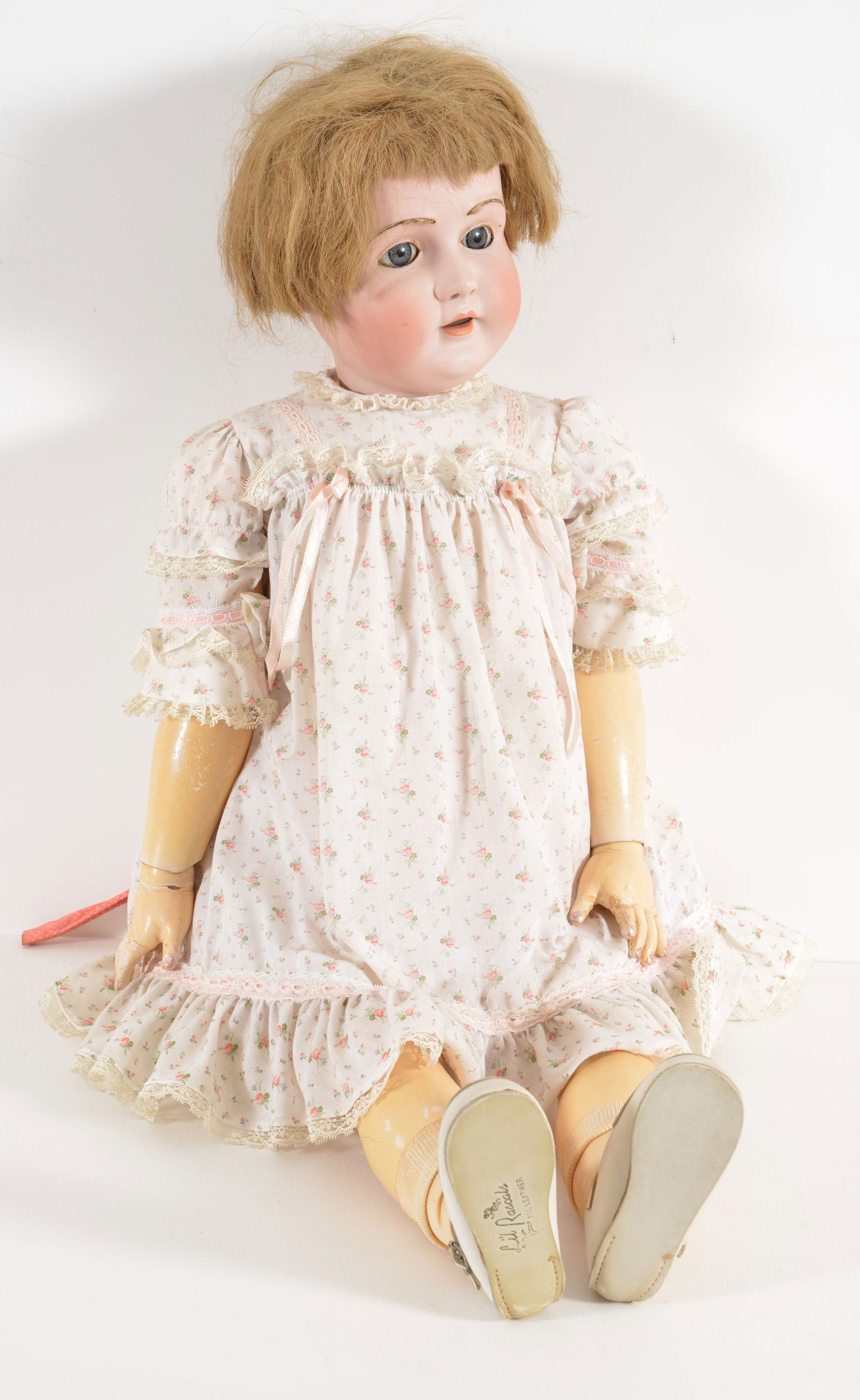 Kestner large German bisque head doll with sleep eyes and composite body, circa, 1900. Bisque head: Kestner large German bisque head doll with sleep eyes and composite body, circa, 1900. Bisque head incised Made in Germany 18 1/2, 196. Period white floral dress. Length 35 in.